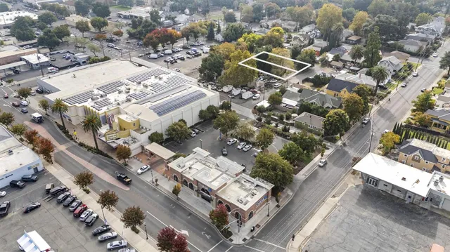 an aerial view of a house with a mountain