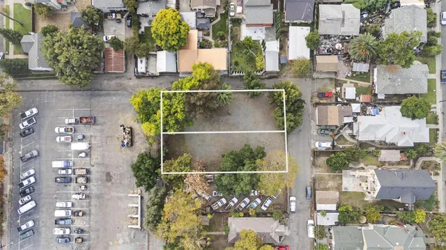 an aerial view of a residential apartment building with a yard