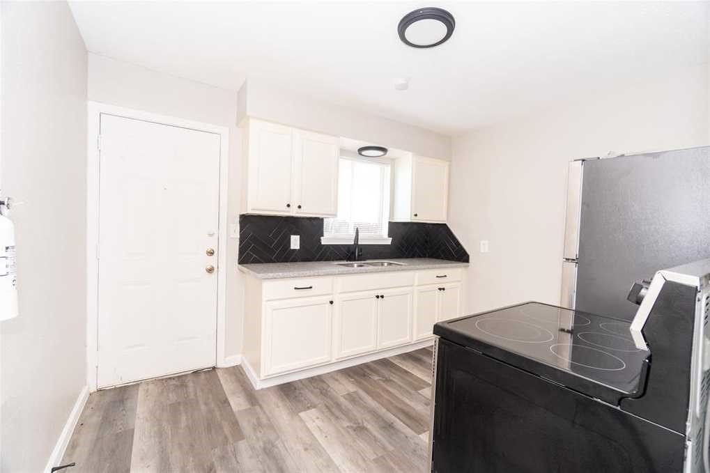 5022 Mallow Street, Unit 7 Houston, TX 77033 - Photo 2 of 20 a kitchen with a sink and a stove