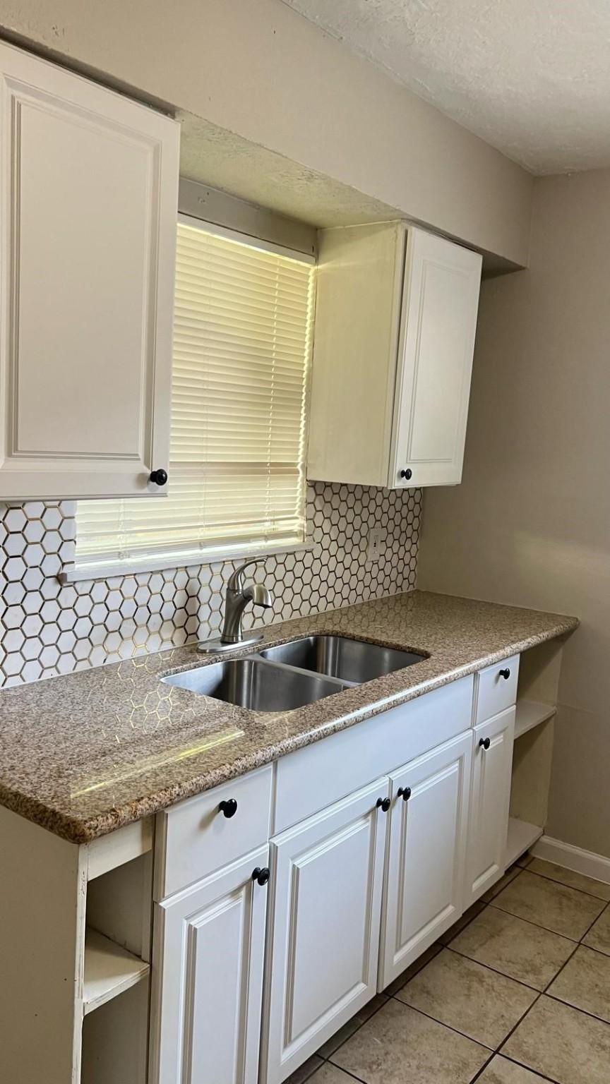 5022 Mallow Street, Unit 7 Houston, TX 77033 - Photo 5 of 20 a kitchen with a sink and cabinets