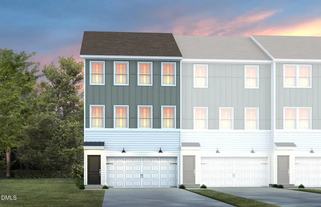 a front view of a building with a garden