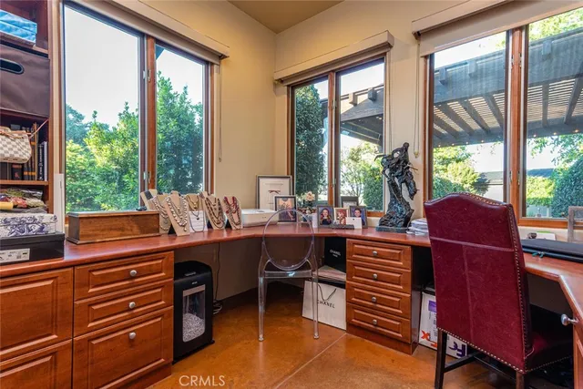 a living room with furniture a window and a flat screen tv
