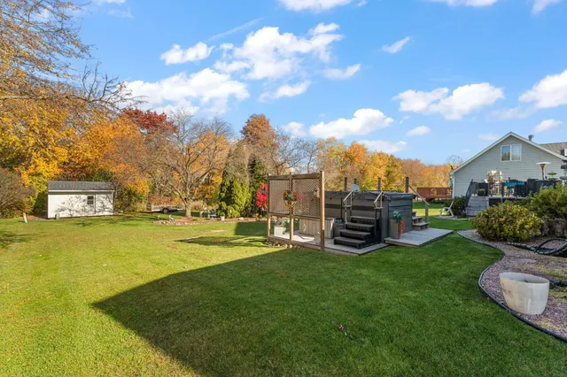 a view of a chairs and table on the wooden deck