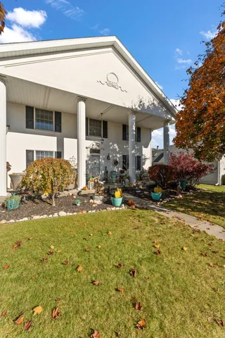 a front view of house with yard and trees