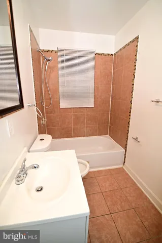 a bathroom with a bathtub and a sink