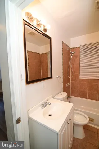 a bathroom with a toilet a sink and a mirror