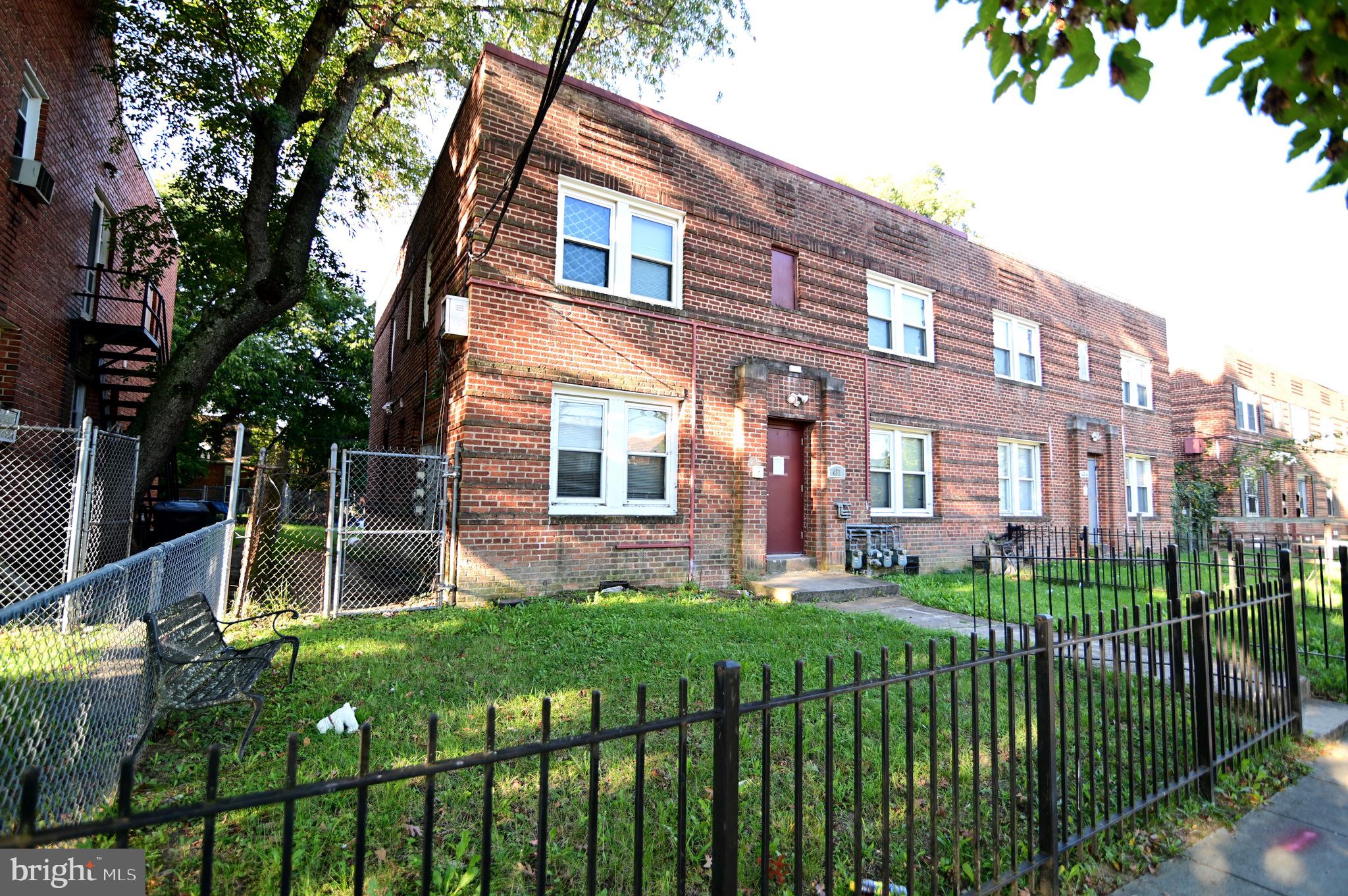 431 Mellon Street Southeast, Unit 2 Washington, DC 20032 - Photo 23 of 24 a front view of a house with a yard and green space