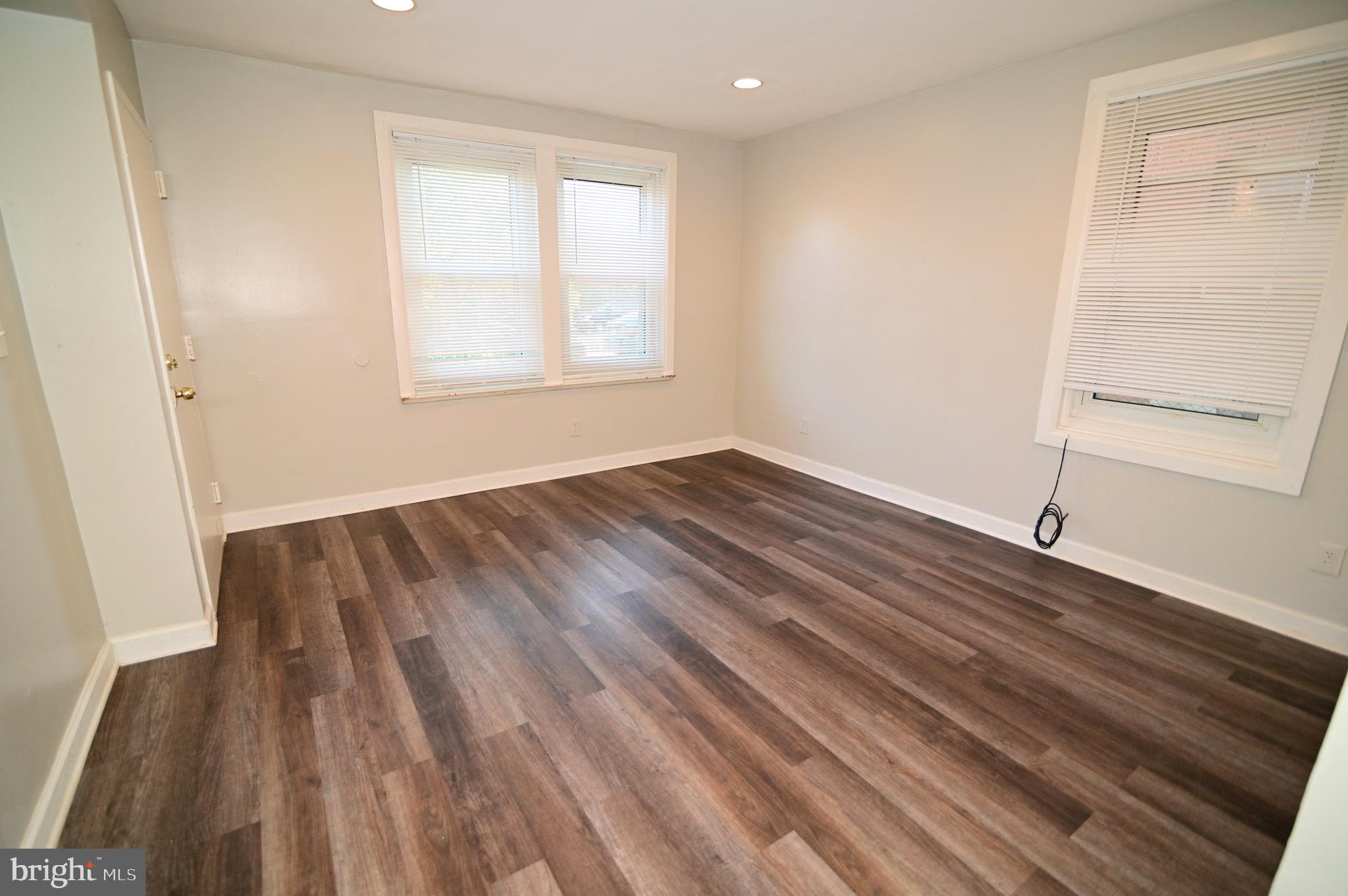 431 Mellon Street Southeast, Unit 2 Washington, DC 20032 - Photo 6 of 24 a view of a room with wooden floor and window