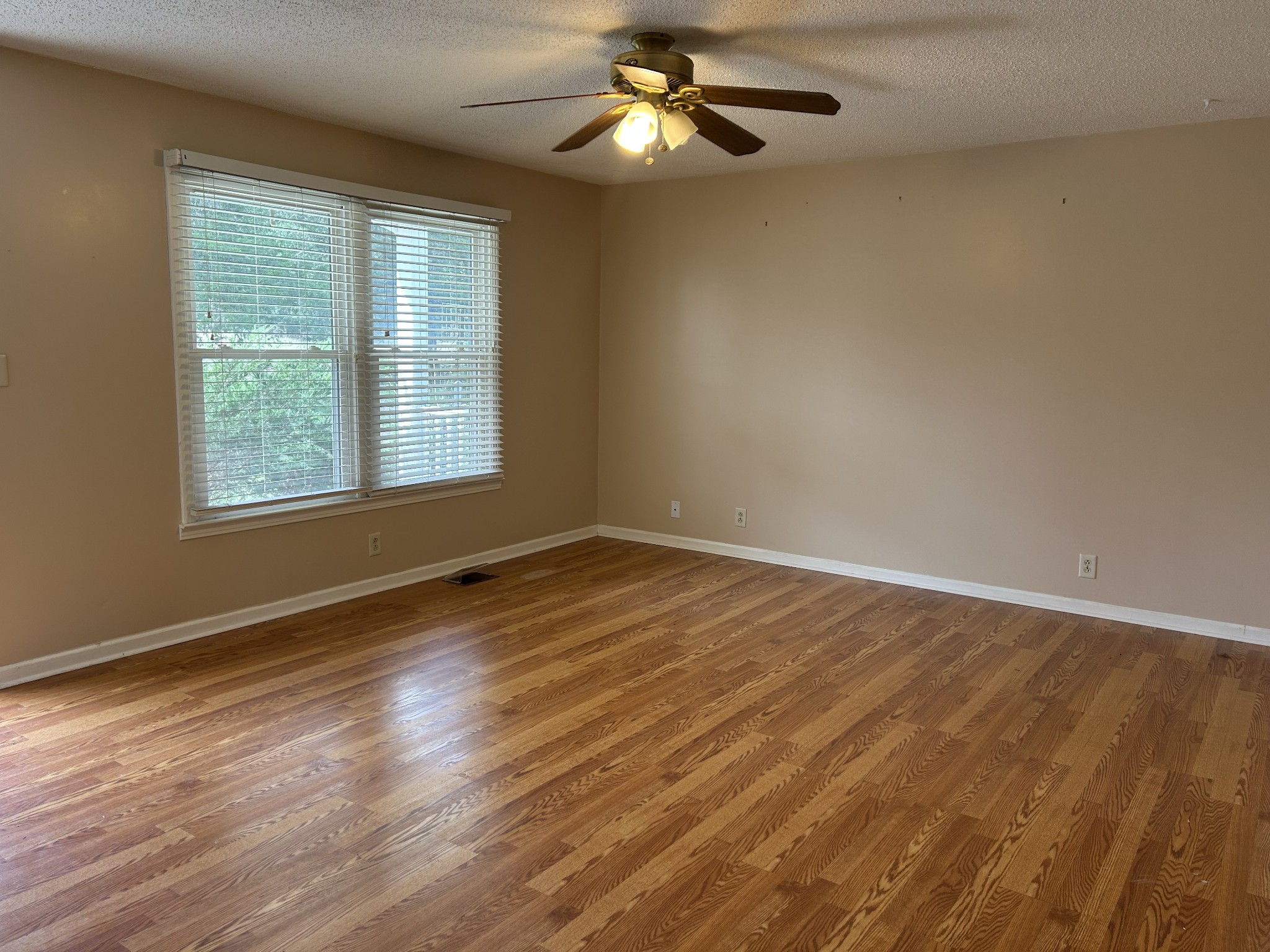 2319 7 Mile Ferry Road Clarksville, TN 37040 - Photo 2 of 15 a view of an empty room with wooden floor and a window