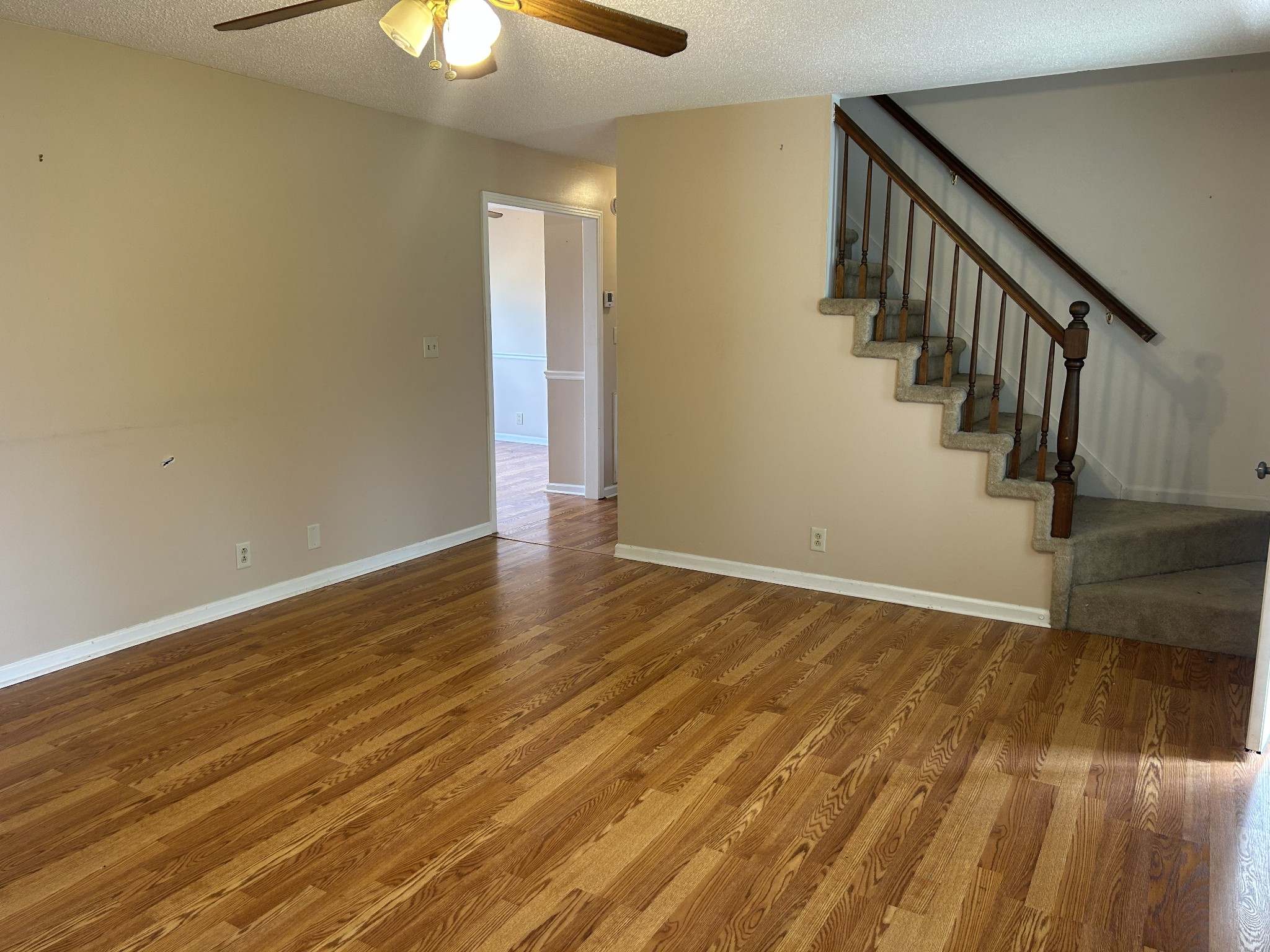 2319 7 Mile Ferry Road Clarksville, TN 37040 - Photo 3 of 15 a view of an empty room with wooden floor and a chandelier fan