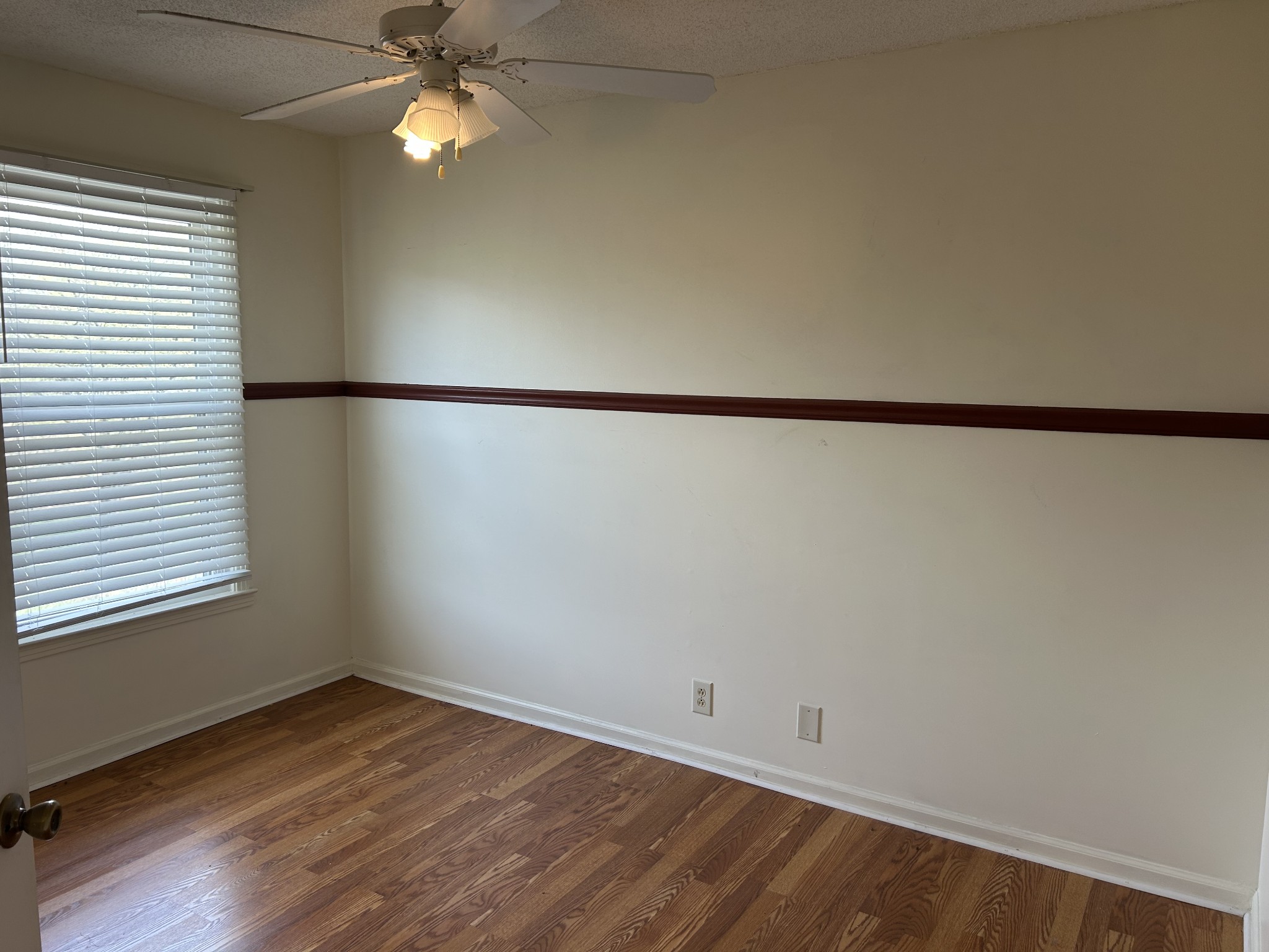 2319 7 Mile Ferry Road Clarksville, TN 37040 - Photo 7 of 15 an empty room with wooden floor and fan