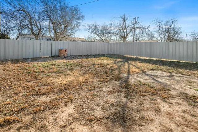 a view of yard covered with snow in front of house