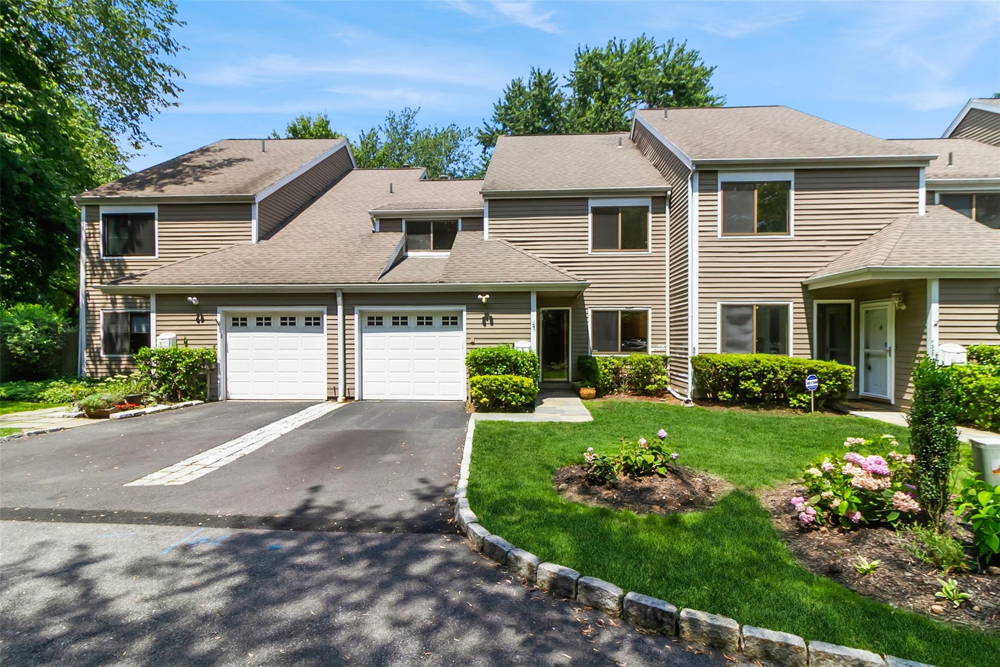 a front view of a house with a garden
