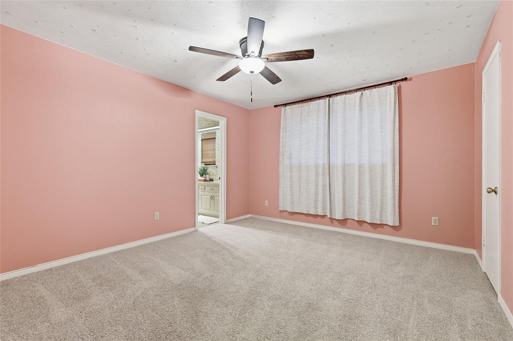 823 Ridgecrest Circle Denton, TX 76205 - Photo 23 of 40 Spacious room featuring carpeting, a ceiling fan, and a window with drapes
