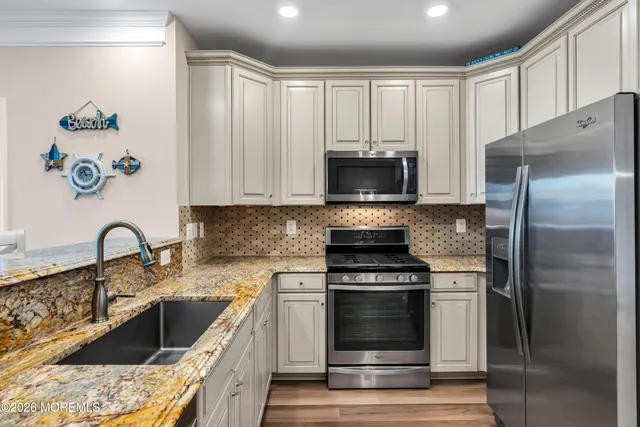 a kitchen with a sink stove and refrigerator