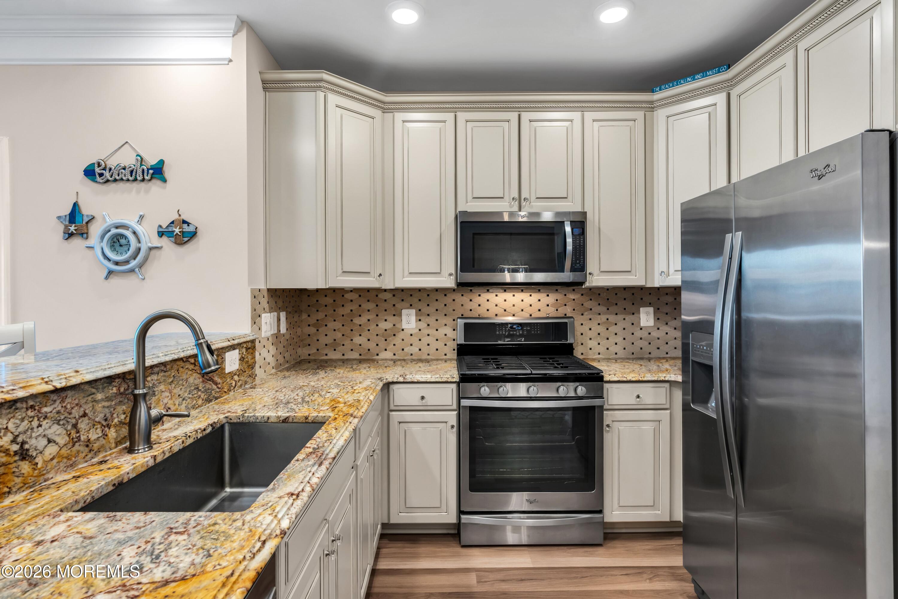 2201 River Road, Unit 4303 Point Pleasant, NJ 08742 - Photo 13 of 36 a kitchen with a sink stove and refrigerator