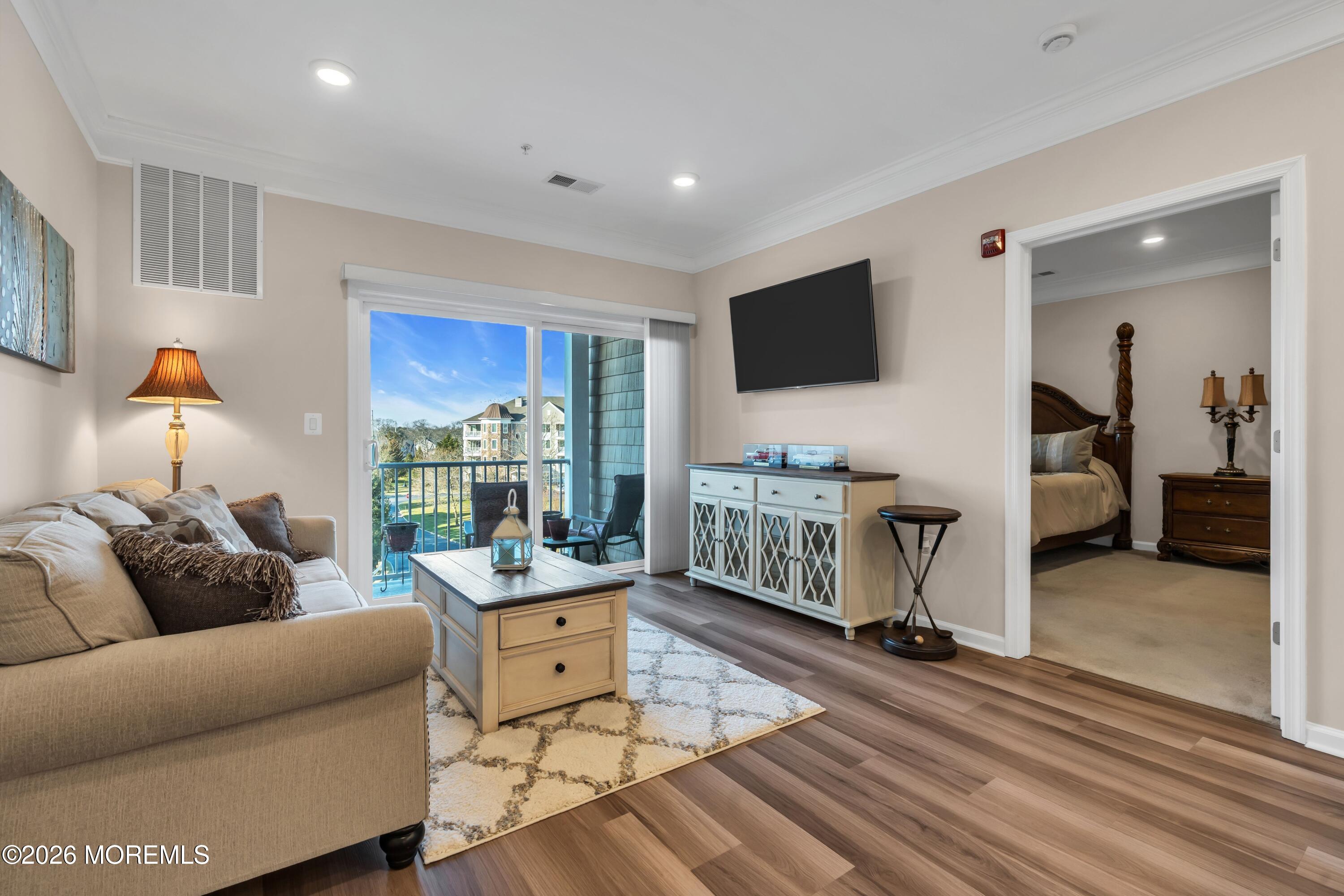 2201 River Road, Unit 4303 Point Pleasant, NJ 08742 - Photo 18 of 36 a living room with furniture and a flat screen tv