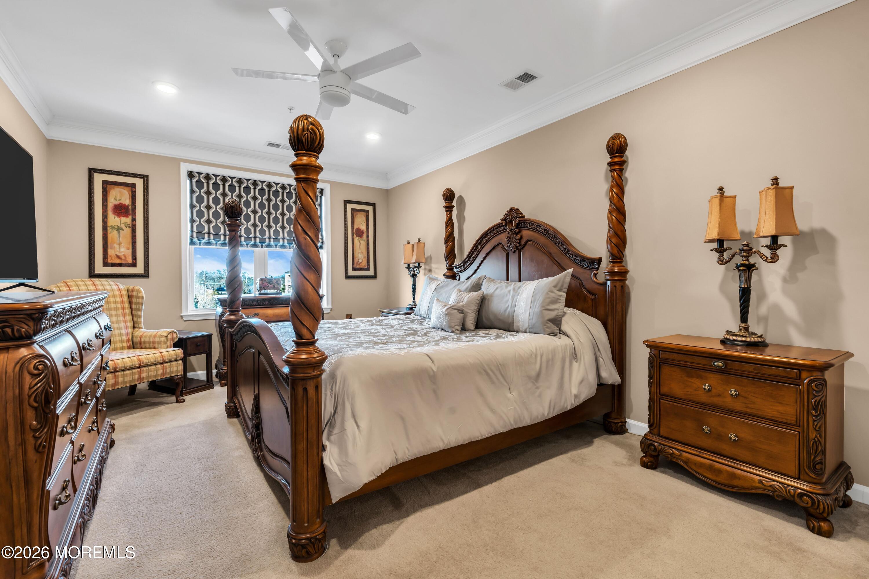 2201 River Road, Unit 4303 Point Pleasant, NJ 08742 - Photo 24 of 36 a bedroom with a bed and a chandelier