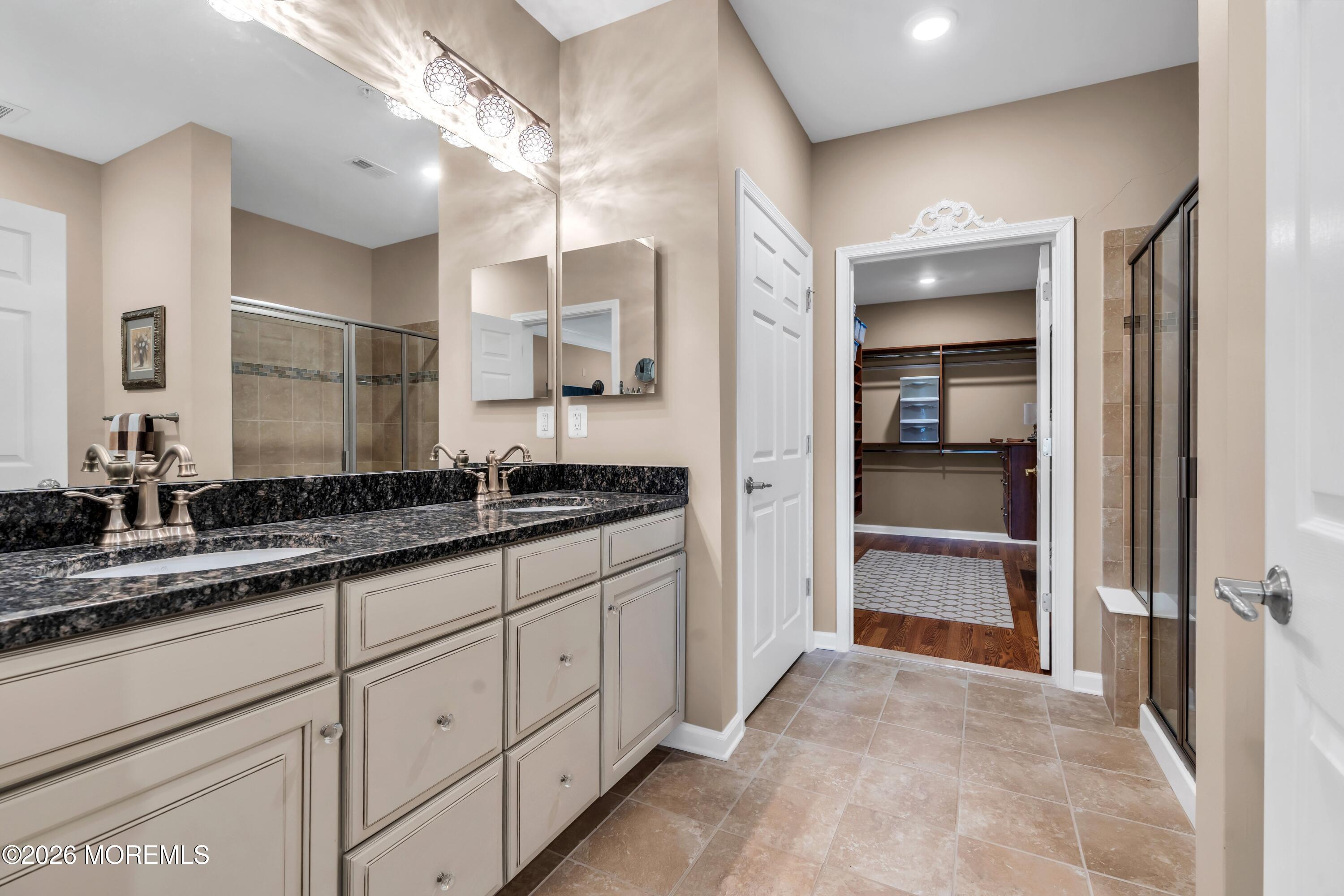 2201 River Road, Unit 4303 Point Pleasant, NJ 08742 - Photo 27 of 36 a bathroom with a sink and a mirror