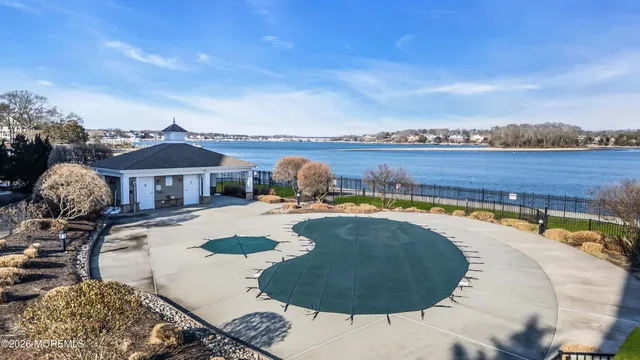 a swimming pool with outdoor seating and barbeque area