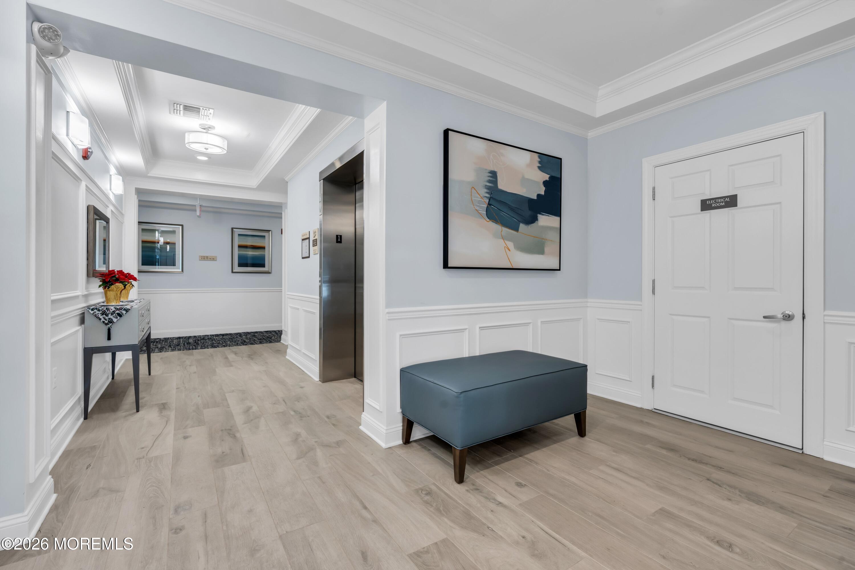 2201 River Road, Unit 4303 Point Pleasant, NJ 08742 - Photo 4 of 36 a living room with furniture and a wooden floor