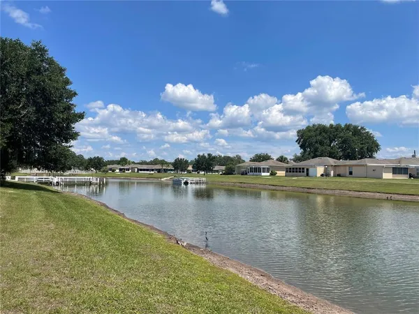 a view of a lake with houses in the background