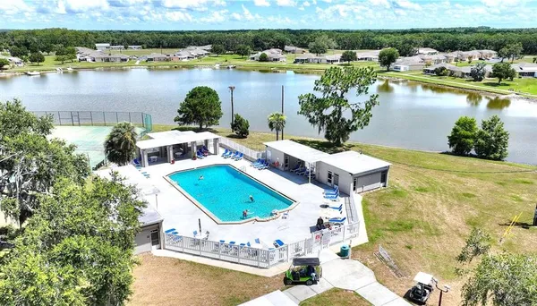 aerial view of a house with outdoor space and lake view