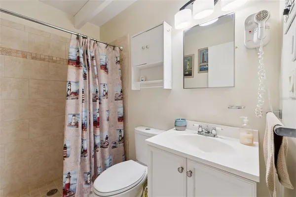 a bathroom with a sink toilet and shower
