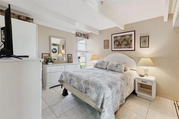 a bed room with a bed and a tv
