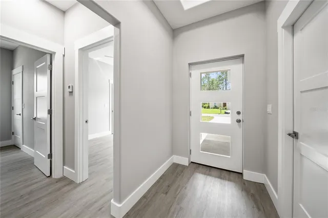 a view of hallway with wooden floor