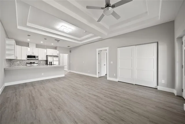 a view of kitchen with stainless steel appliances refrigerator stove microwave and cabinets