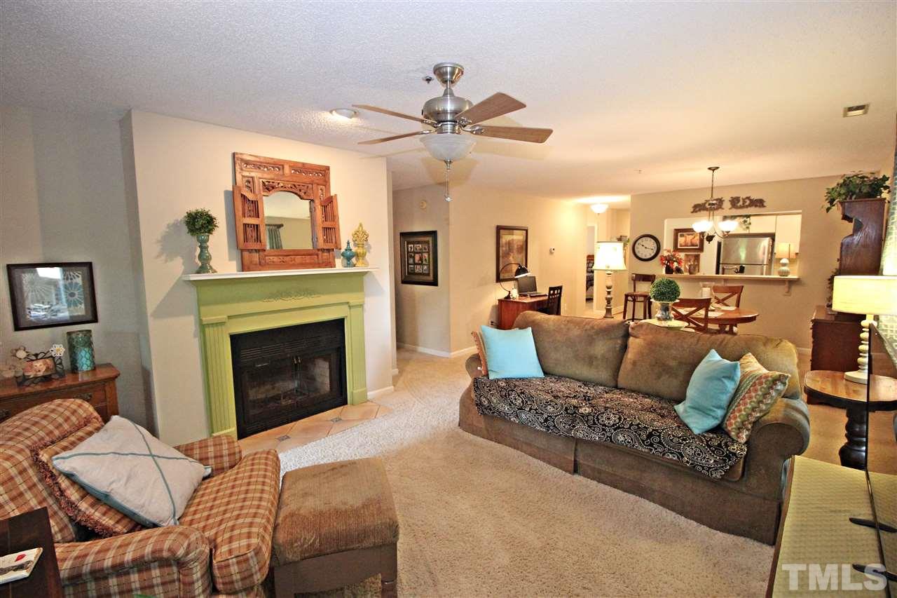 921 Springfork Drive Cary, NC 27513 - Photo 11 of 22 a living room with furniture a fireplace and a flat screen tv