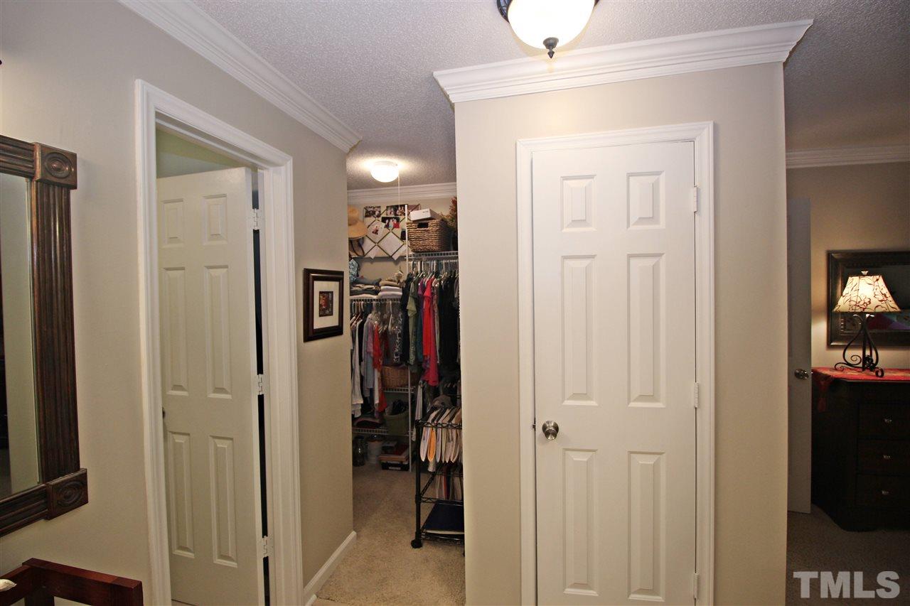 921 Springfork Drive Cary, NC 27513 - Photo 15 of 22 a view of a hallway with closet and a livingroom view