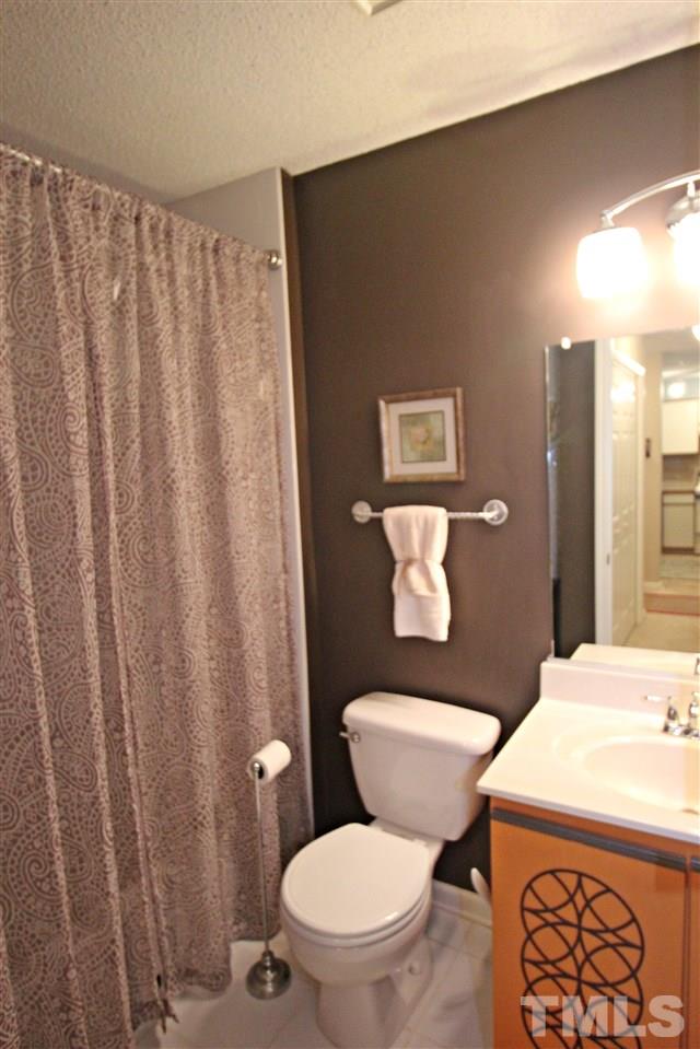921 Springfork Drive Cary, NC 27513 - Photo 17 of 22 a white toilet sitting next to a bathroom sink