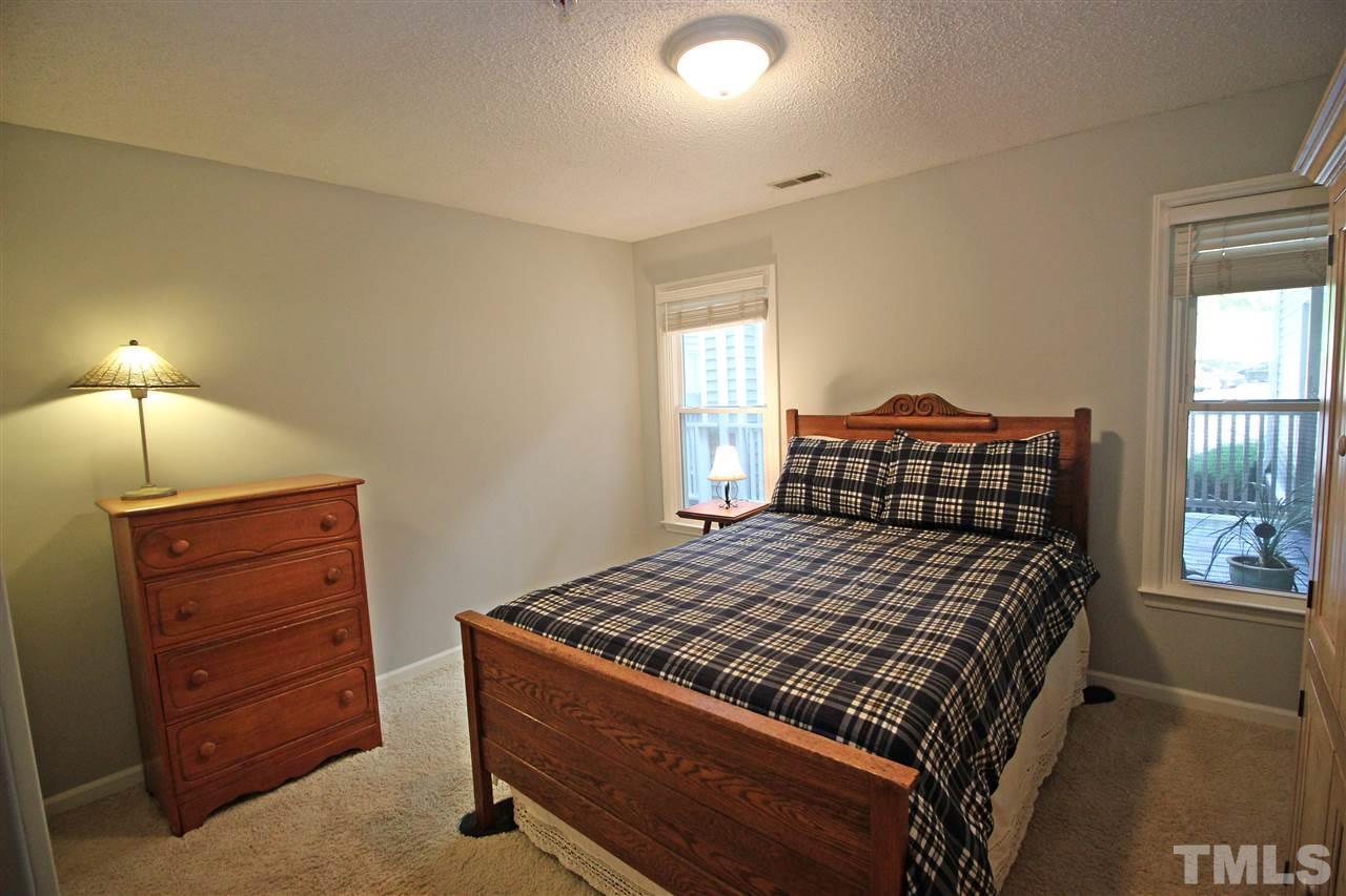 921 Springfork Drive Cary, NC 27513 - Photo 18 of 22 a bedroom with a bed and a window