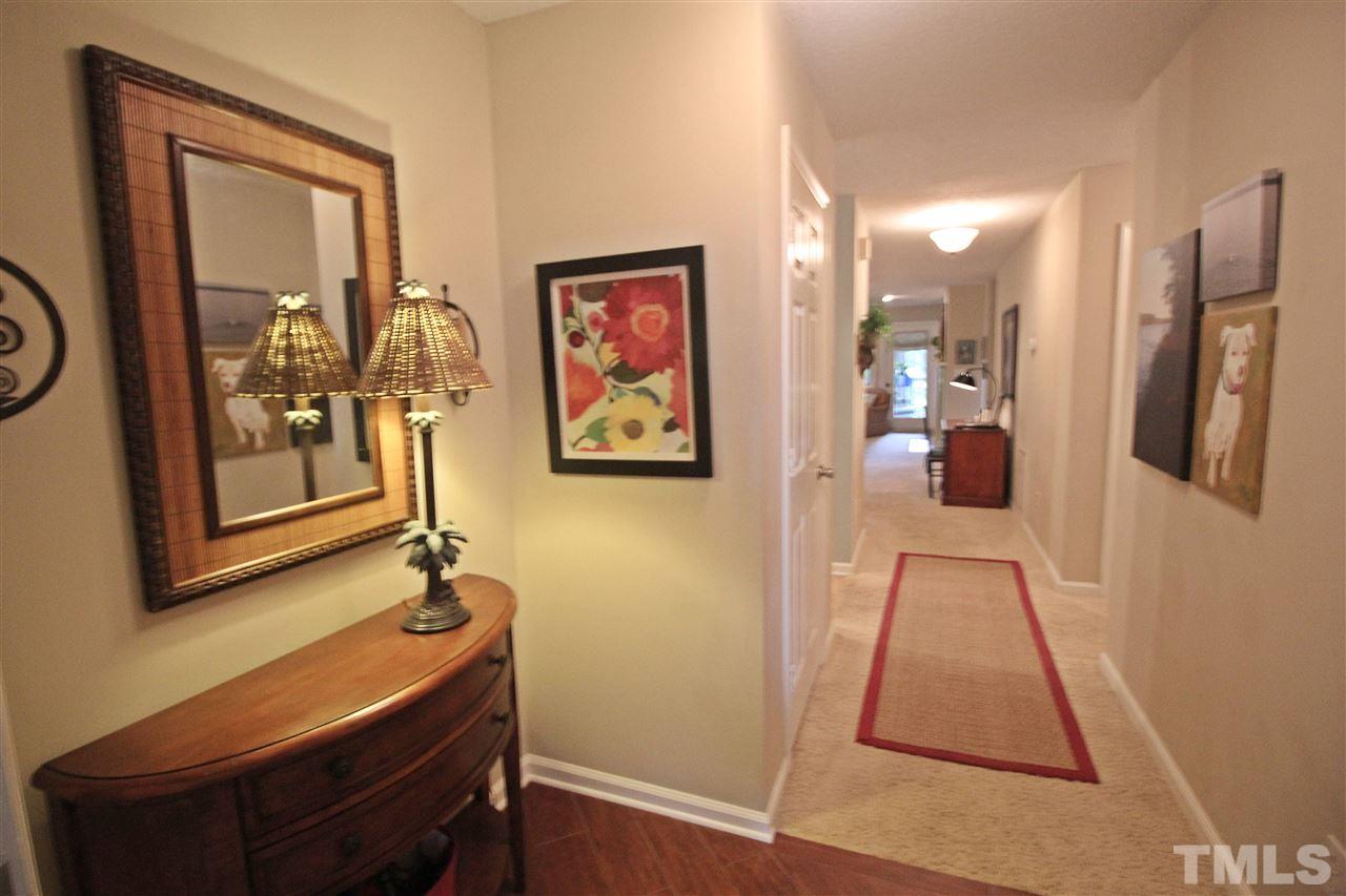 921 Springfork Drive Cary, NC 27513 - Photo 2 of 22 a view of a hallway with paintings on the wall