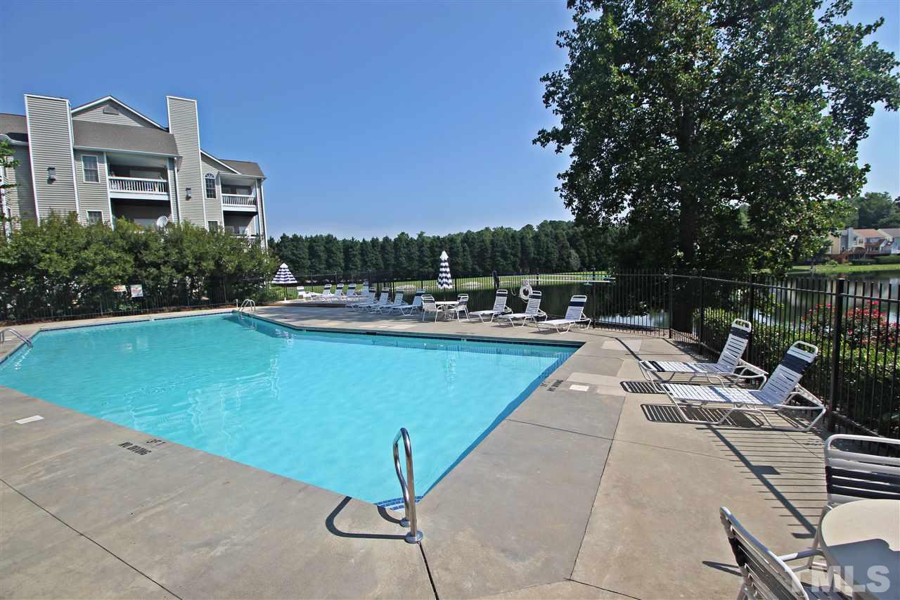 921 Springfork Drive Cary, NC 27513 - Photo 21 of 22 a view of a swimming pool with a lounge chairs