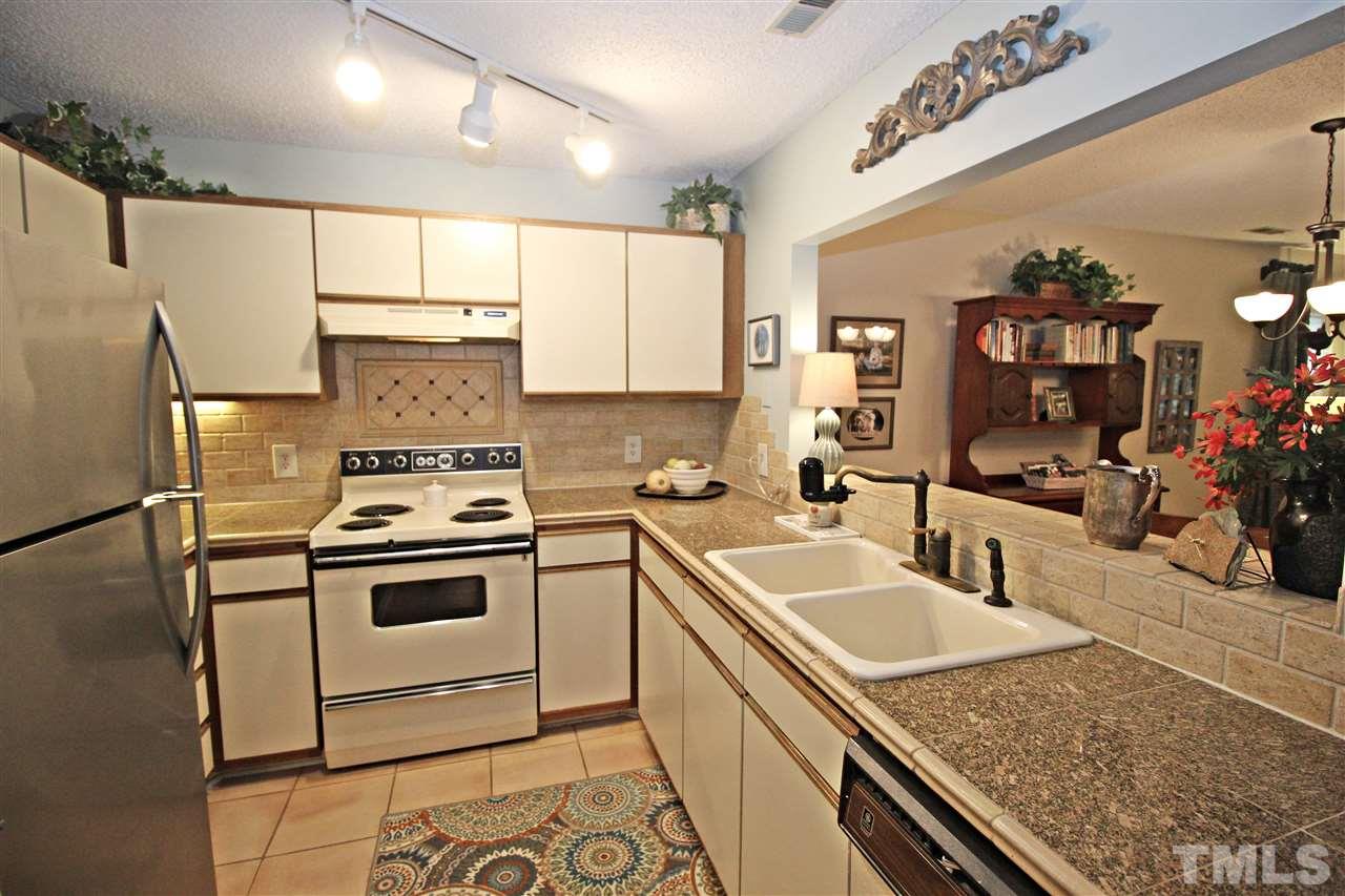 921 Springfork Drive Cary, NC 27513 - Photo 4 of 22 a kitchen with a sink cabinets and stainless steel appliances