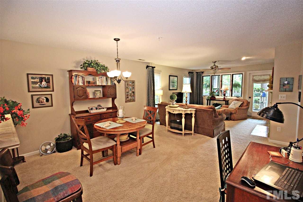 921 Springfork Drive Cary, NC 27513 - Photo 6 of 22 a living room with furniture a chandelier and a dining table