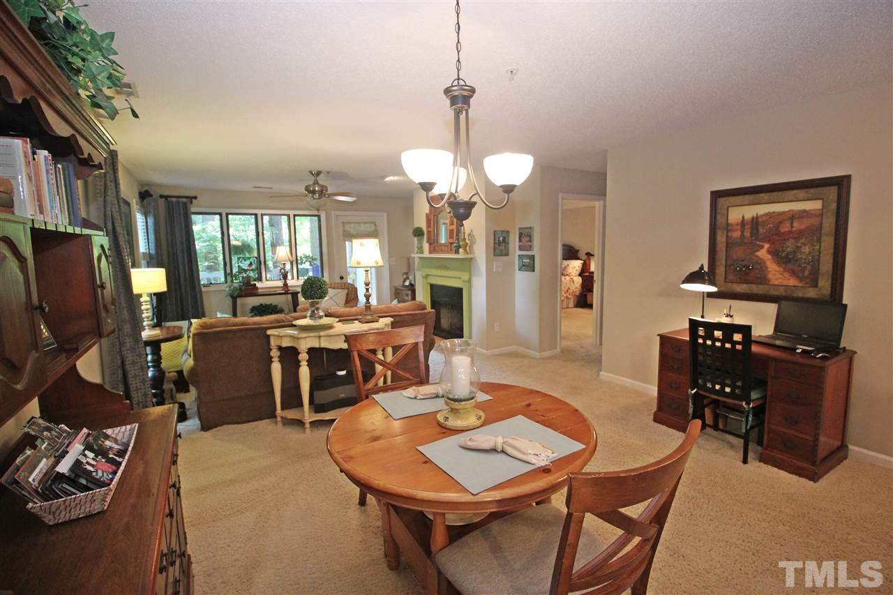 921 Springfork Drive Cary, NC 27513 - Photo 7 of 22 a living room with furniture a dining table and a piano