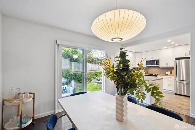 a room with dining table & a chandelier