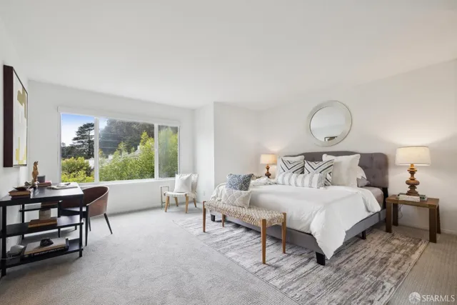 a bedroom with a bed and a mirror