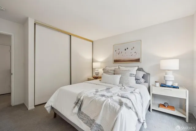 a bedroom with a bed and a table in it