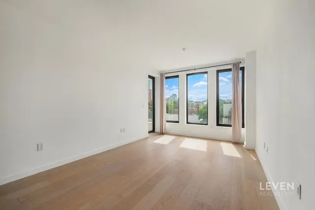 a living room with furniture potted plant and a flat screen tv