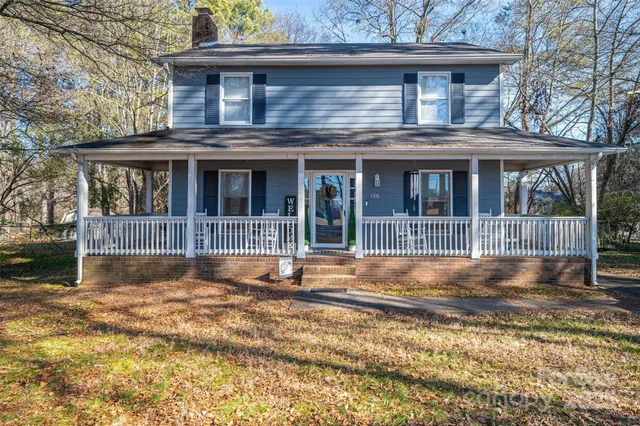 a view of house with yard