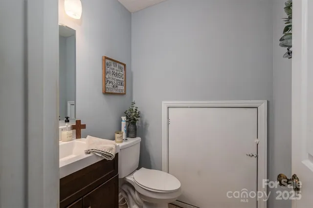 a bathroom with a sink a toilet and shower curtain