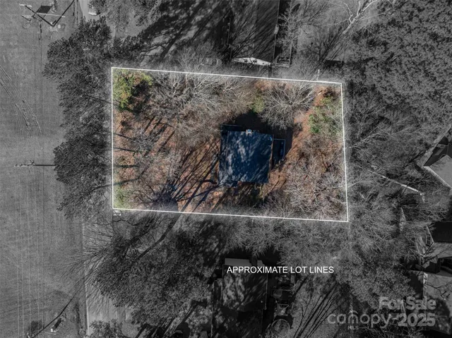 a view of a house with a yard and wooden fence