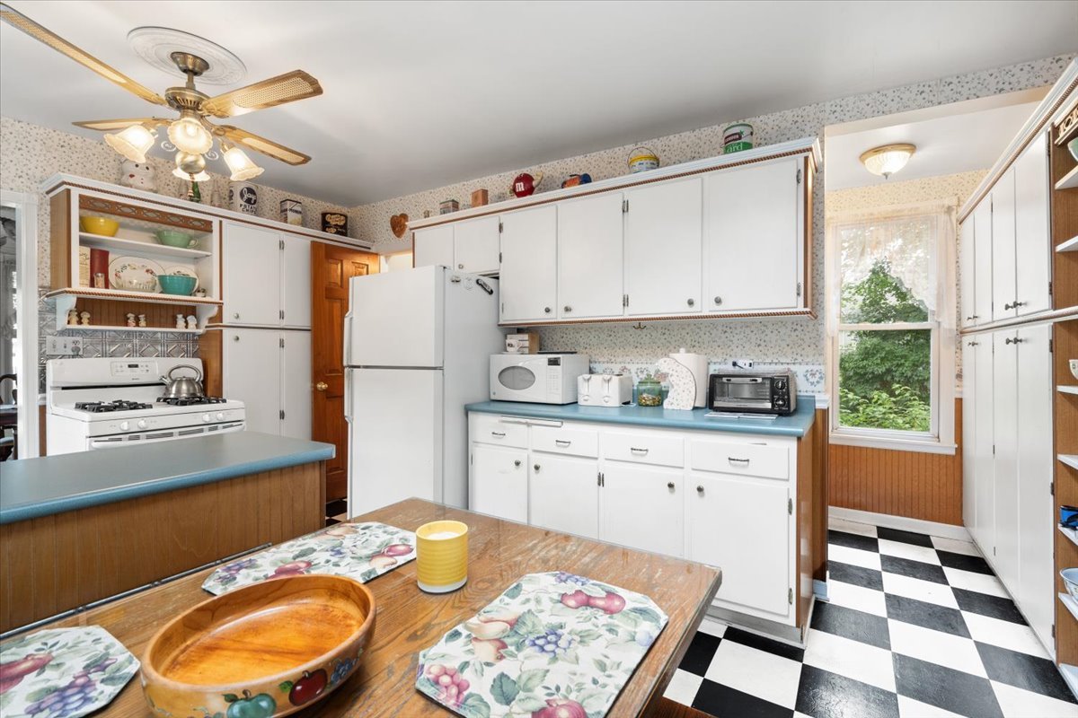 116 Spring Street Cary, IL 60013 - Photo 17 of 45 a kitchen with granite countertop stainless steel appliances a sink and a refrigerator