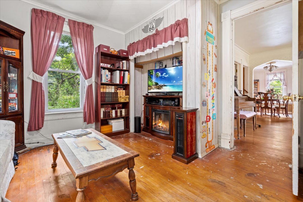 116 Spring Street Cary, IL 60013 - Photo 21 of 45 a living room with furniture a bookshelf and a large window