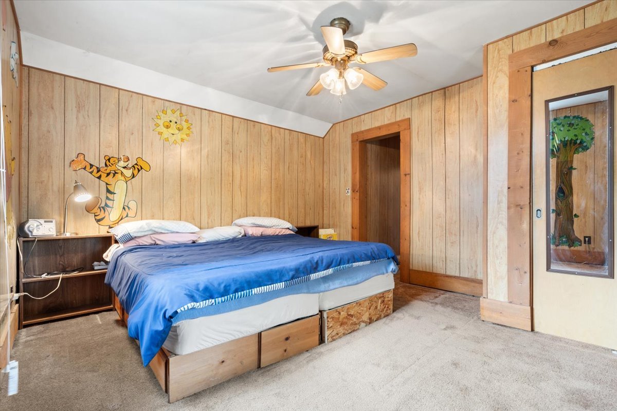 116 Spring Street Cary, IL 60013 - Photo 27 of 45 a bedroom with a bed and a chandelier